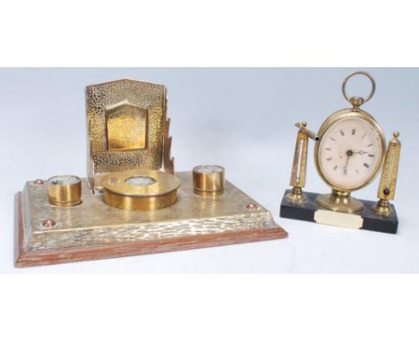 A good early 20th Century brass desk tidy having a central brass covered inkwell holder with engraved floral&nbsp; decoration