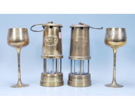 Two 20th Century brass miners lamps each with oval plaques reading 'Hockley Lamp &Limelight Company' together with two Indian
