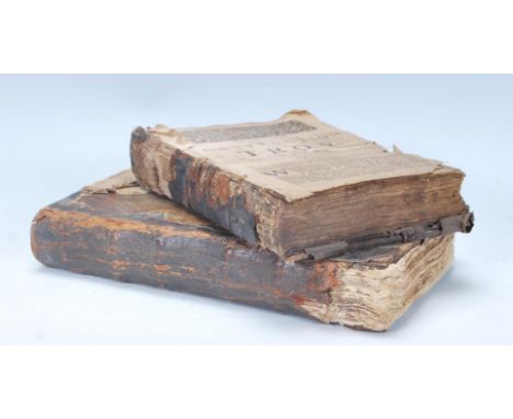 An interesting pair of 17th Century antique leather bound book. One entitled 'The Destruction Of Troy, The First Book' sadly 