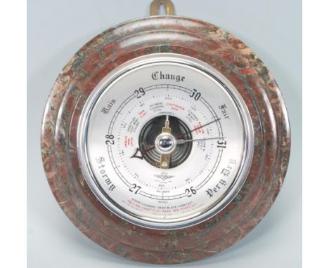 A late 20th Century Shortland wall barometer of round form having a silvered dial with black enamelled numeral and pierced de