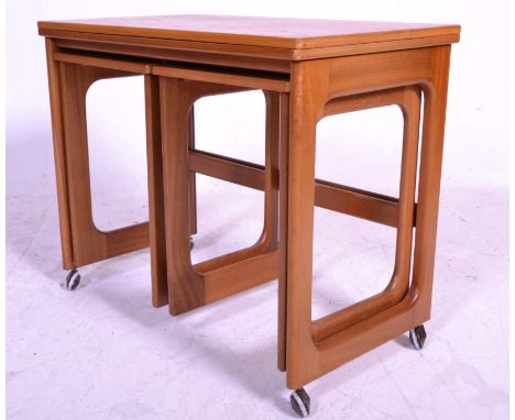 A 20th Century retro teak wood nest of three tables by Macintosh and Co consisting of one long table with two short. The larg