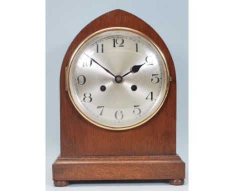 An early 20th century mahogany cased English bracket clock having inset 8 day brass movement. The mahogany case of spire shap