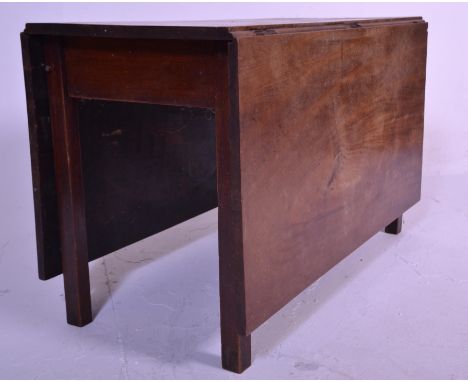 A 19th Century Georgian mahogany drop leaf / gate leg dining table of rectangular form being raised on square cut leg support