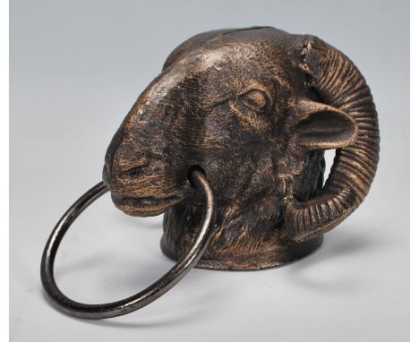 An antique style cast iron door knocker in the form of a Rams head. Measures 13 cm high x 21 cm long.