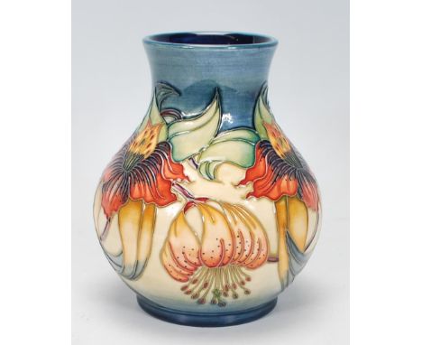 A Moorcroft vase of globular form in the&nbsp;Anna Lilly pattern. Tubelined on a blue and cream ground. Impressed and painted