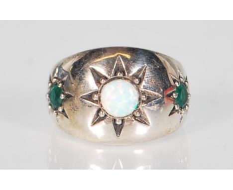 A stamped 925 silver gypsy style ring. The ring is set with the central stone of an opal. Surrounding the stone is an etched 