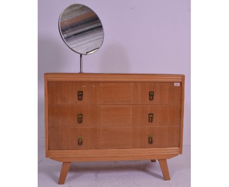 A vintage retro 20th Century light oak dressing table / chest of drawers having a single stem circular mirror above three str
