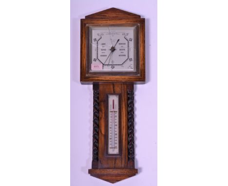 A mid 20th Century oak cased banjo wall barometer having thermometer above flanked by barley twist columns with arched pedime