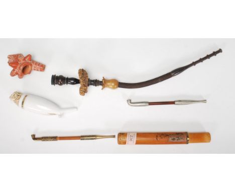 A collection of vintage pipes to include two Opium pipes one in a bamboo carry case, South American clay style pipe bowl, Aus