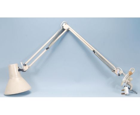 A vintage retro 1970's anglepoise desk lamp having a conical shade on a metamorphic posable arm with a adjustable clamp to th