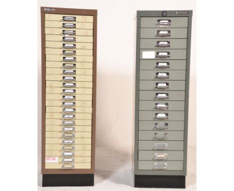 Two 20th Century metal Bisley style Industrial drawer index filing cabinet raised on a plinth base. One having 24 drawers and