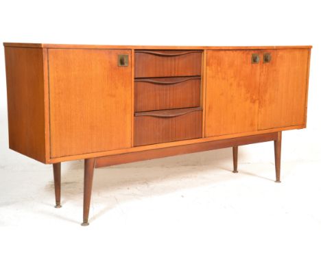 A vintage retro 20th Century teak wood sideboard credenza having an offset central bank of three graduating drawers with sing