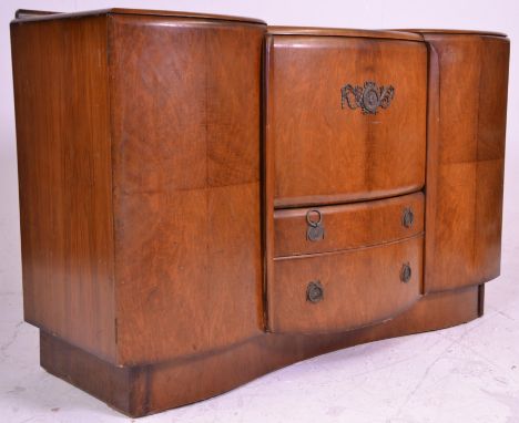 An early 20th Century 1940's art deco walnut cocktail - drinks cabinet sideboard of large proportions having a metamorphic fo