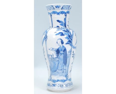 A 19th Century Chinese vase of baluster form having a waisted body hand painted in blue and white having alternating panels d