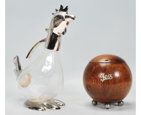 A contemporary glass and silver plated decanter / water jug modelled as a cockerel, moulded glass body hinged head with handl