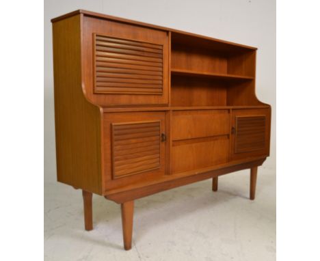 A good retro mid 20th Century teak wood highboard / sideboard credenza having a concave front with open shelf space beside a 