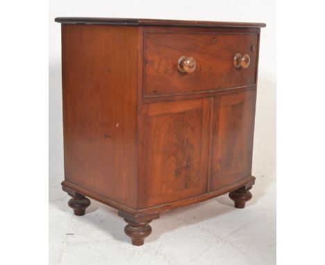 A 19th Century mahogany commode chest formed as a bow front chest, turned handles to the false drawer lifting to reveal turne