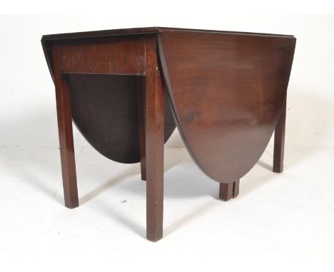 A 19th century Victorian mahogany drop leaf gate leg dining table being raised on squared legs united by stretchers having ga
