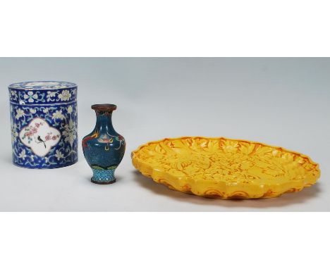 A collection of three Chinese items to include a yellow cinnabar / plate / charger having moulded floral decoration together 