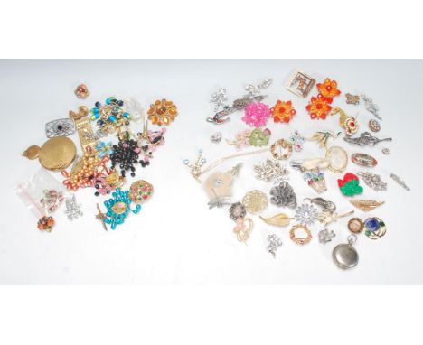 A collection of vintage mid 20th Century brooches to include a Scottish Grouse claw brooch, floral and figurative brooches, m