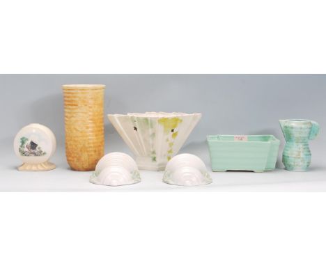 A small group of early 20th Century Art Deco ceramics to include a mint green table vase, a small shaped jug with ribbed body