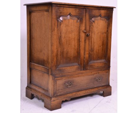 A good quality oak Tv / Cocktail cabinet in the manner of Rackstraw. Raised on block feet with short drawer under double door