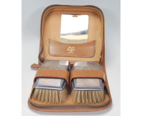 A pair of vintage silver hallmarked clothes brushes, having engine turned decoration with raised gilt initial panels to the c