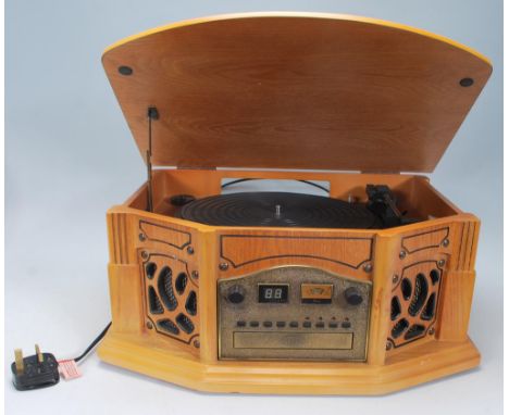 A contemporary antique style hi-fi stereo system in oak wooden effect, The system comprising tape deck, cd player and record 