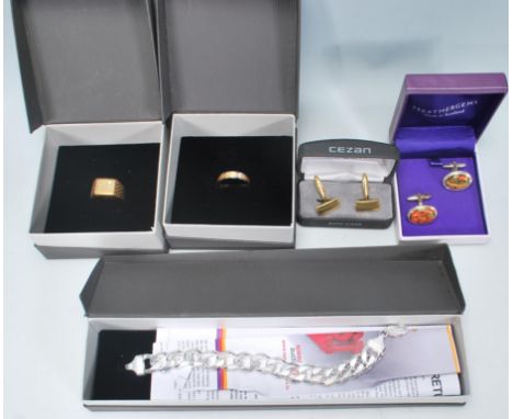 A selection of gentleman's jewellery to include a stamped 925 silver flat link bracelet with a lobster clasp (weight 65.5g.),