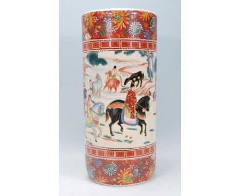 A 20th Century Japanese ceramic stick stand vase of cylindrical form having a central panel hand painted with people travelli