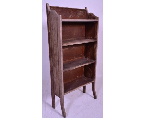 A 20th century rustic campaign style oak folding bookcase shelf. The carved gallery detailed top over a series of fall down s