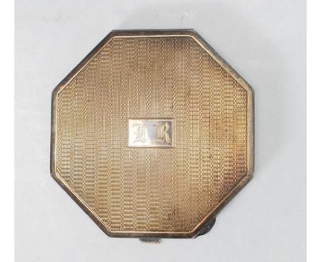 A vintage 20th Century English silver hallmarked compact of octagonal form having an engine turned case with central monogram