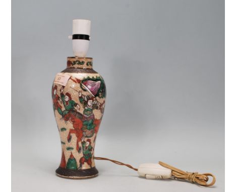 A 20th Century Chinese crackle glaze lamp base of baluster form decorated with hand painted green and red warrior scenes to t