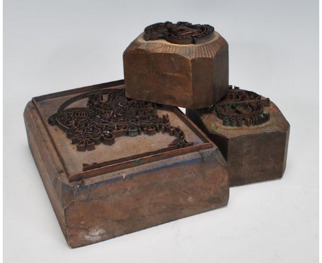 A group of three 20th Century wooden printing blocks one depicting a bird in flight, one reading 'dog and whip' and another r