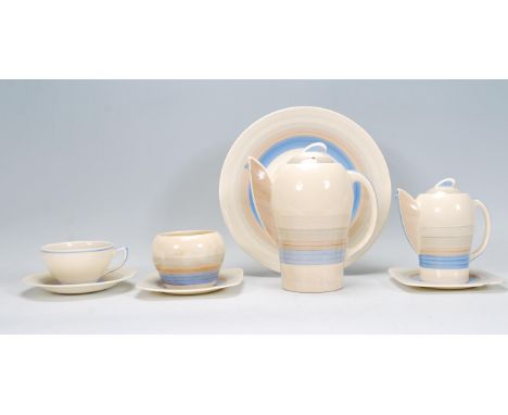 An early 20th Century Art Deco Susie Cooper bachelors / part tea service of shapely form having blue and creams banding decor