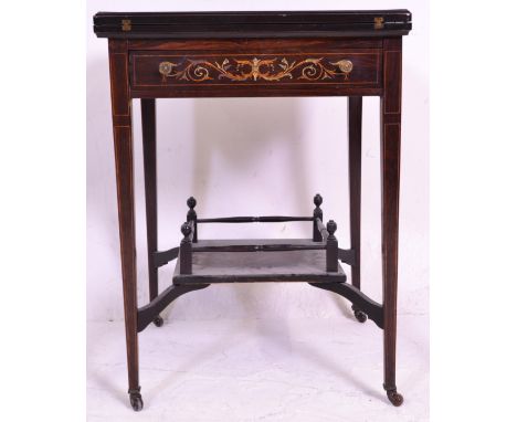 An Edwardian rosewood and marquetry envelope card table in the manner of Edwards &amp; Roberts, the floral decorated marquetr