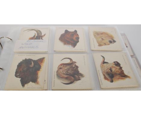 An Album of vintage John Players cigarette trade cards. Full sets include Cap Badges, Wild Animals Series One and Two (Large 