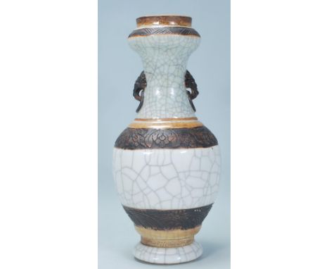 A 19th Century Chinese Guangxu crackle glaze vase having a bulbous body with flared neck being banded in relief with raised d