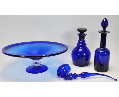 A group of Bristol blue glassware to include two decanters one of bell shaped form and the other having a waisted neck, both 