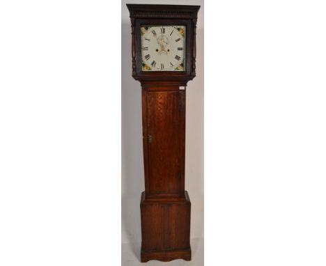 A 19th Century oak cased grandfather / longcase clock having&nbsp;a painted face with floral decoration and roman numerals to