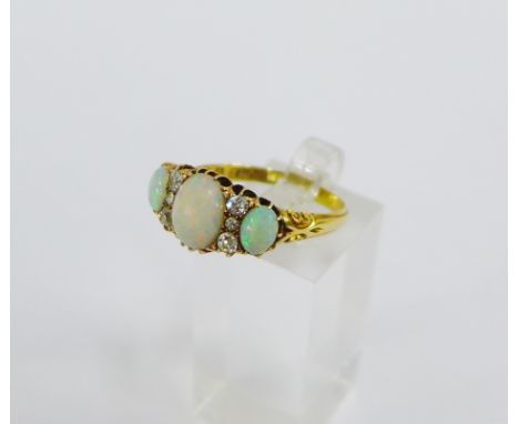 Late Victorian 18 carat gold opal and diamond dress ring, with three oval cabouchon opals and six bright cut diamond spacers,