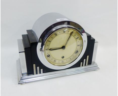 Art Deco chrome mantle clock with silvered chapter ring and Roman numerals on four bun feet, 22 x 34cm 