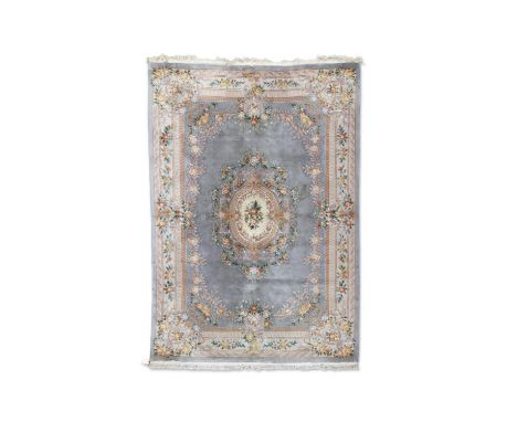 A CHINESE CARPET, 431 X 308cCMwool pile on cotton warp with a scroll and medallion design on pale ground