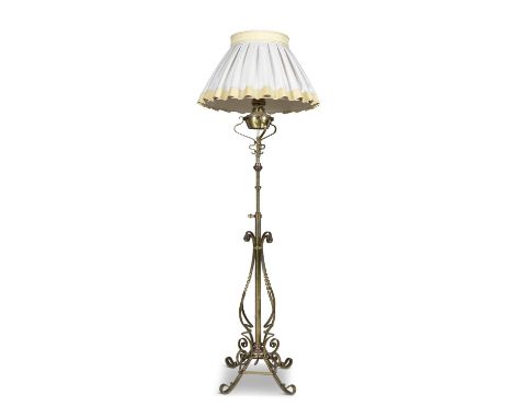 AN ARTS AND CRAFTS BRASS FLOOR LAMP, INCLUDING SHADE, 154cm high, excluding fitments(E)ELECTRICAL GOOD IN NEED OF REWIRING AR