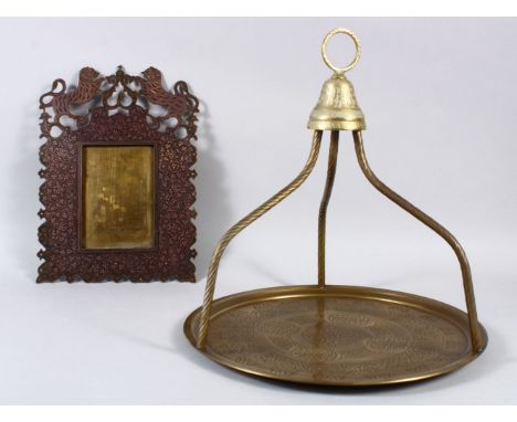 A 20TH CENTURY INDIAN MURADABAD BRASS FRAME , made for the English market, 31cm high x 22cm wide. with one other item.