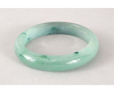 A GOOD 19TH / 20TH CENTURY CHINESE CARVED JADEITE BANGLE, 7cm &amp; internal 5cm.