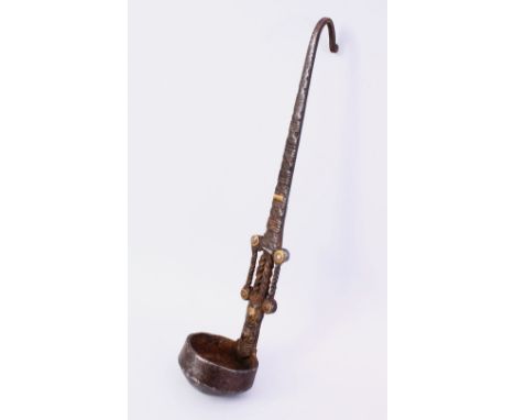 AN UNUSUAL 15TH/16TH CENTURY PERSIAN WROUGHT IRON AND BRASS INLAID HANGING OIL LAMP OR LADLE, 36cm long.