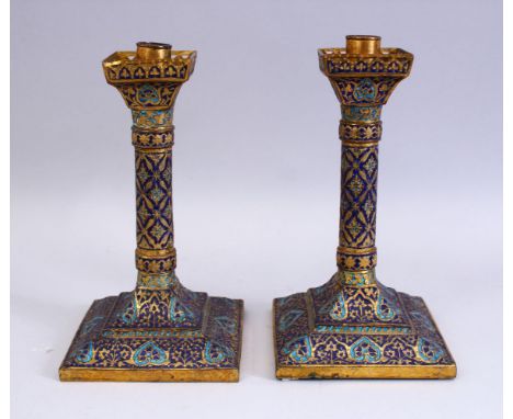 A GOOD 19TH CENTURY INDIAN KASHMIRI GILT &amp; ENAMEL CANDLESTICKS, the sticks with enamel decoration depicting foliate, 24cm