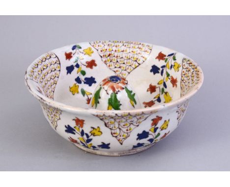 A GOOD EARLY TURKISH KUTAHYA POTTERY LEMON SQUEEZER,  decorated with floral design, 14.5cm diameter.