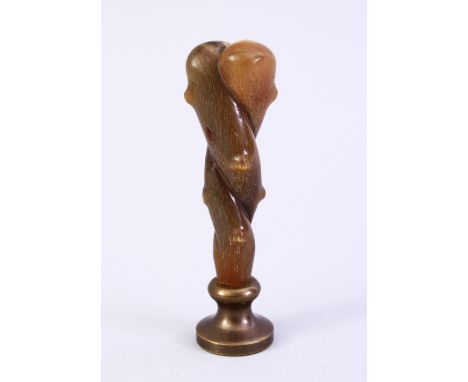 A GOOD 19TH CENTURY CHINESE CARVED RHINO HORN HANDLE SEAL, carved in the form of natural subject, with a carved seal section,